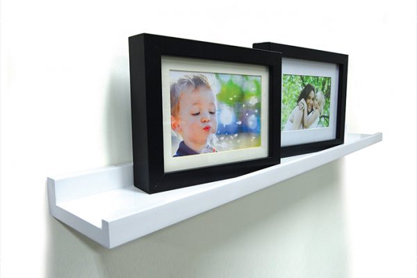 Flexi Storage Decorative Shelving Photo Shelf 600x100x35mm fitted on wall with several photos on the shelf